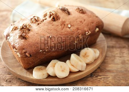 Tasty banana nut bread on wooden board
