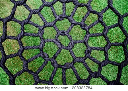 A black net on green grass in the park