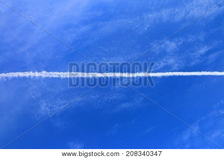 Trail of airplane in the blue sky.