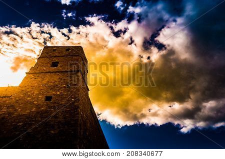 Hammamet, Tunisia. Image of architecture of old medina with dramatic sky at sunset time.