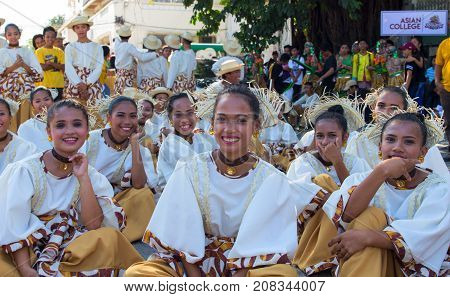 Dumaguete Philippines - 16 September 2017: Sandurot Festival actors resting before performance. Carnival with dancing in colorful costumes. Beautiful dancers smiling in camera. Philippines tradition