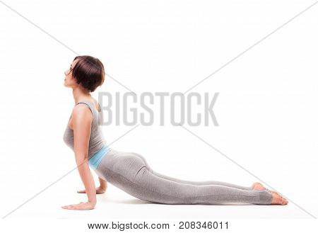 young beautiful woman yoga posing on isalated white studio background