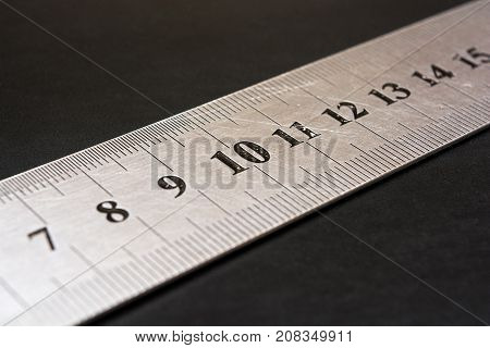 Metal ruler closeup. Measuring tool. Stationery. The number ten in focus. Centimeters. Millimeters.
