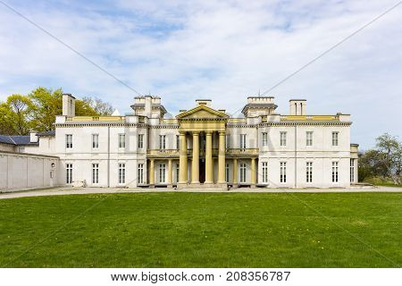 front view of majestic dundurn castle in city of hamilton in ontario canada blue sky clouds park area green grass