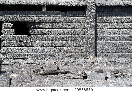 Burned charred planks on wood walll closeup in a fire
