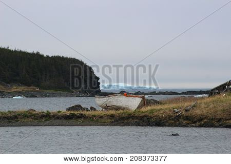 Thawing out after a long winter. Iceberg floating in the bay near St. Lunaire-Griquet, Newfoundland