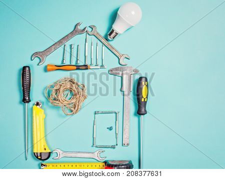 Home improvement concept. Set work hand tool for construction or repair of house. Rebuilding DIY. Group of tools in shape house.