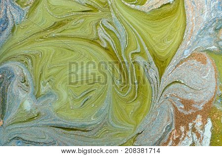 Marbled blue abstract background with golden sequins. Liquid marble ink pattern