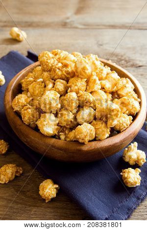 Homemade Caramel Popcorn In Wooden Bowl Close Up