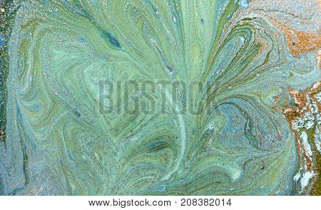 Marbled blue abstract background with golden sequins. Liquid marble ink pattern