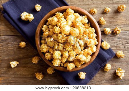 Homemade caramel popcorn in wooden bowl. Caramel popcorn