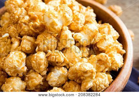 Homemade Caramel Popcorn In Wooden Bowl Close Up