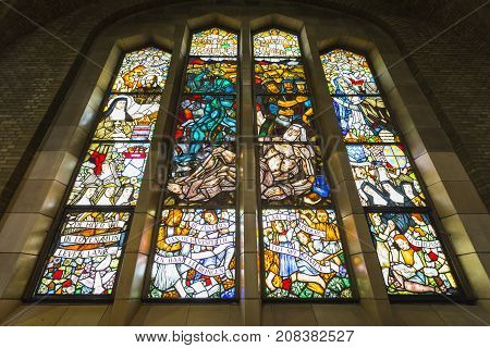 BRUSSELS BELGIUM - JUNE 19 2016: Detail of one of the stained flass windows on the second floor of the Basilica of The Sacred Heart. Brussels Belgium.