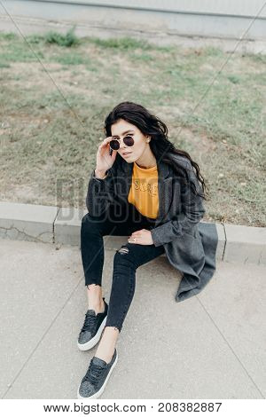 Portrait Of Stylish Modern Young Curly Woman In Coat Sunglasses