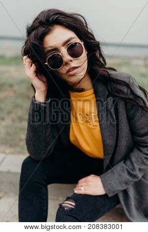 Portrait Of Stylish Modern Young Curly Woman In Coat Sunglasses