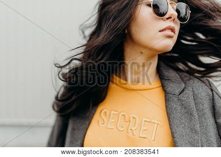 Portrait Of Stylish Modern Young Curly Woman In Coat Sunglasses