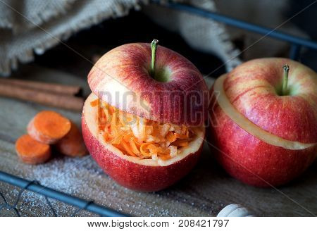 A healthy salad of carrots and apples sprinkled with sugar in an apple. Healthy dessert