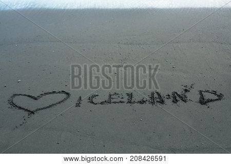 the inscription and heart on the black sand - love Iceland
