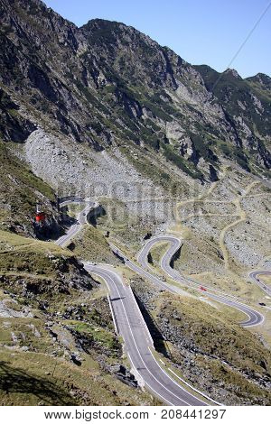 Red cable car in the mountains over the road- Carphatians