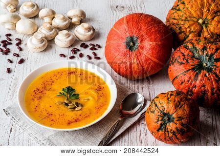 Pumpkin soup with seeds and parsley. Vegan food.