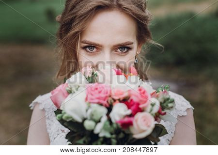 Beautiful Gorgeous Bride With Wedding Bouquet Portrait. Woman Posing In Beautiful Nature Outdoors. H