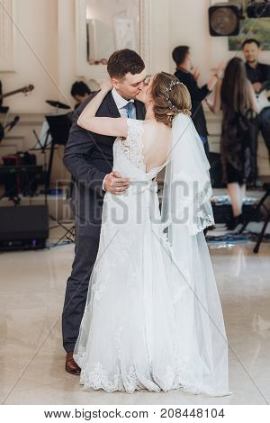 Beautiful Gorgeous Bride And Groom Performing First Dance. Happy Wedding Couple Dancing In Restauran
