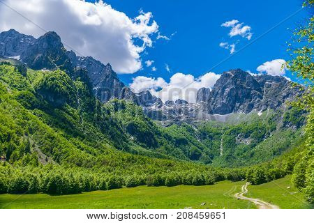 Picturesque Meadows And Forests Are Located Among The High Mountains.
