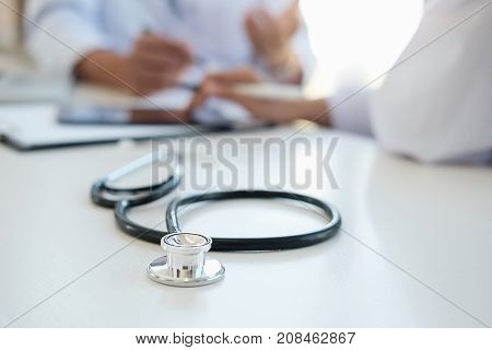 Patient Listening Intently To A Male Doctor Explaining Patient Symptoms Or Asking A Question As They