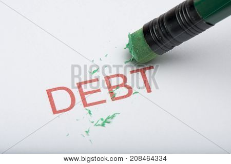 Pencil Eraser Trying To Remove The Word 'debt' On Paper