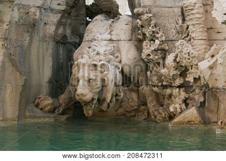 Lion statue on the Fountain of the Four Rivers (Fontana dei Quattro Fiumi) in the Piazza Navona in Rome, Italy