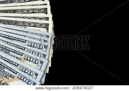 Stack of one hundred dollar bills. Stack of cash money in hundred dollar banknotes. Heap of hundred dollar bills isolated on black background