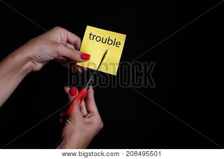 Photo on a dark background. Yellow sticker. Steel scissors.