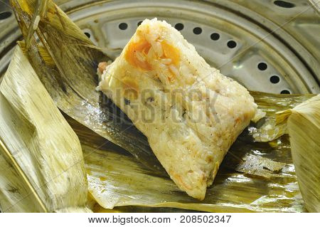 sticky rice steam with pork and salt egg wrapped in banana leaf of Chinese Duanwu festival on pot