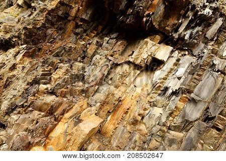 Diagonal rock material texture. Macro of old mountain stones pattern background.