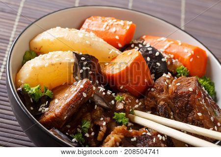 Korean Cuisine: Ribs Stewed With Mushrooms, Pears And Carrots Close-up. Horizontal
