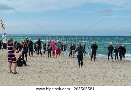 Melbourne, Australia - February 11, 2017: swimmers waiting to take to the water at Edithvale Beach in Melbourne's south eastern surburbs.