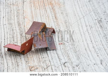 Several pieces of scrap iron rods placed on the concrete floor.