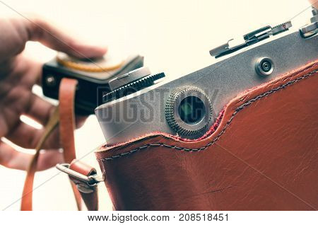 user shoots on an old camera uses an exposure meter
