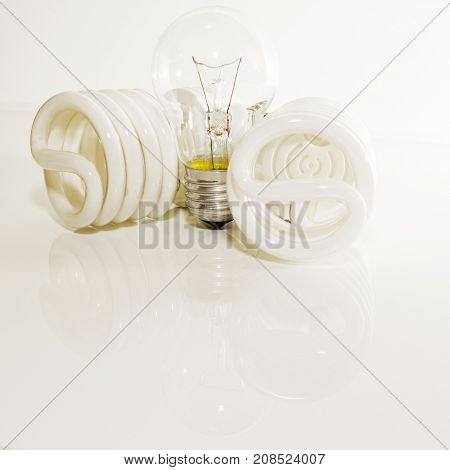 Several different led bulbs and compact fluorescent lamps with the size of the male screw base E27 on a light background
