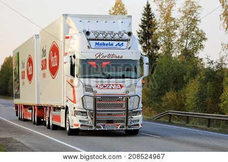 JYVASKYLA FINLAND - SEPTEMBER 23 2017: Customized Next Generation Scania R of Kortetmaa for temperature controlled transport hauls foodstuff along highway at sunset in Central Finland.