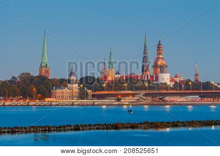 Evening view on the embankment of the Daugava River and the spiers of churches in Riga. Latvia.