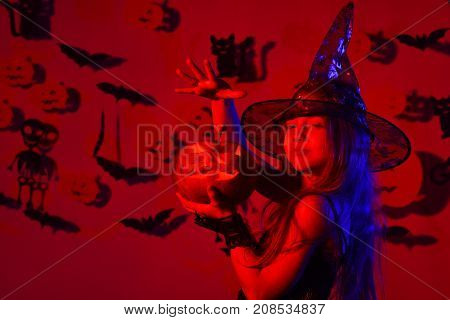 Halloween Party And Decorations Concept. Little Witch Wearing Black Hat