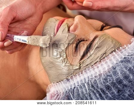 Collagen face mask. Facial skin treatment. Face of woman of elderly woman 50-60 years old receiving cosmetic procedure in beauty salon close up. Professional cosmetologist. Healing clay for the face.