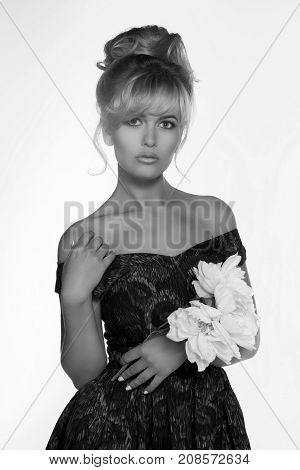 portrait of a beautiful blonde woman in retro dress 50-s style . copy space. vintage look. babetta haircut. monochrome black and white photo