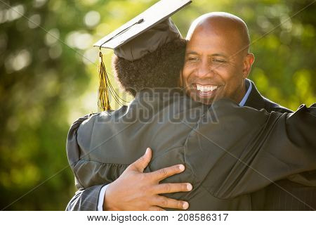 Father hugging his son on his graduation day.
