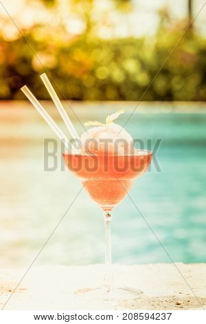 Frozen Strawberry Margarita Cocktail At The Edge Of A Resort Pool.  Concept Of Luxury Vacation