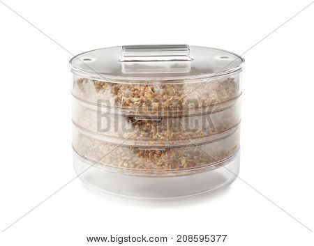 Sprouter with wheat grass seeds on white background