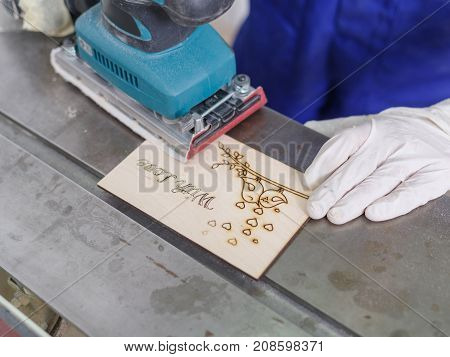 A carved plate on which the patterns and inscriptions are burned out which the master processes with a special tool