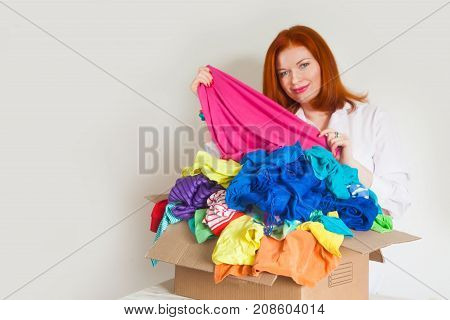 A Woman Is Busy With The Clutter In Her Wardrobe.