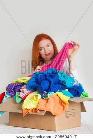 A Woman Is Busy With The Clutter In Her Wardrobe.